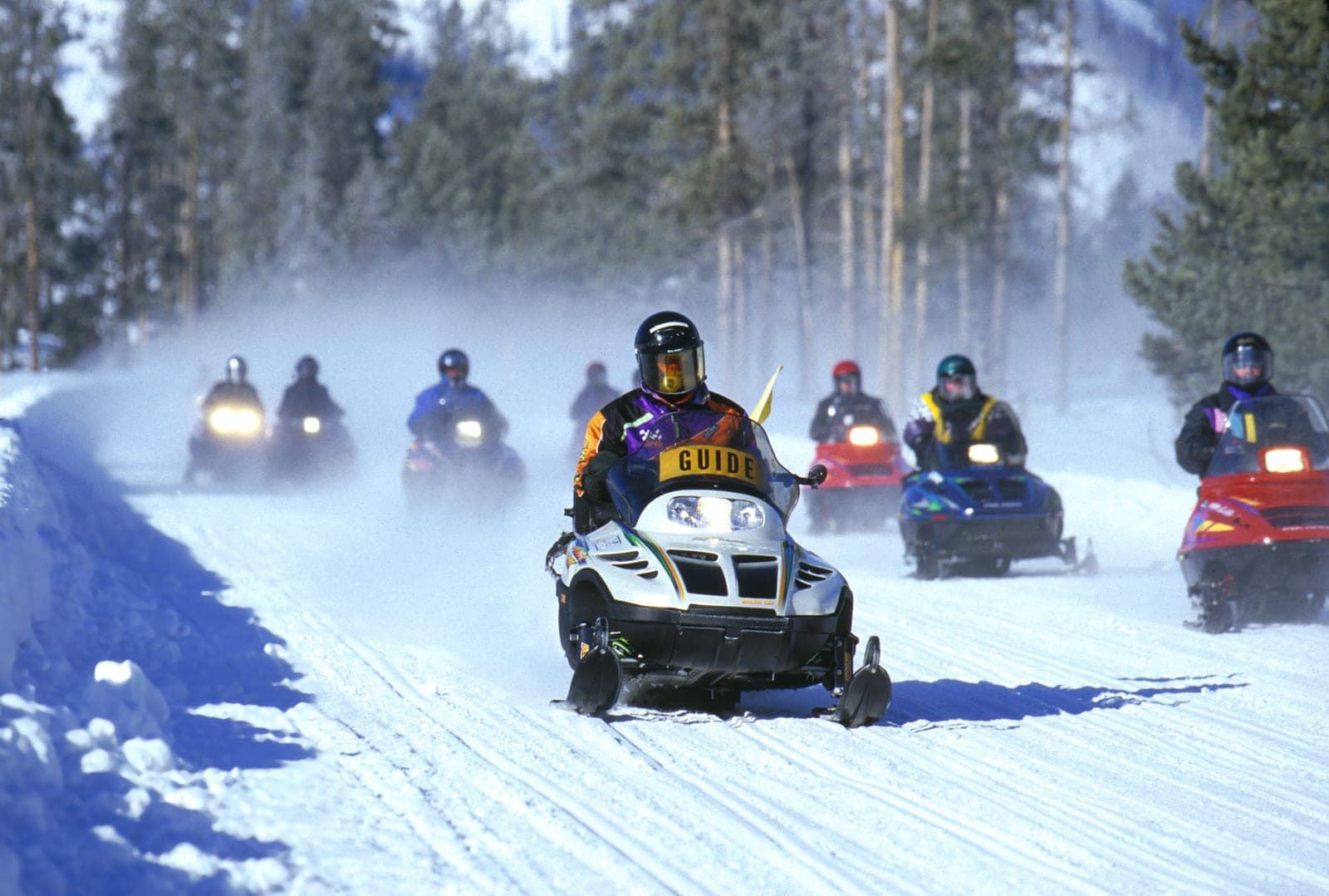 Group of riders on a guided snowmobile tour